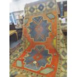 A Turkish rug having two central motifs and geometric designs 336cm x 244cm