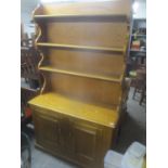 A modern light oak dresser having a plate rack above two cupboard doors 201 h x 118cm w