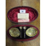 A cased set of two Victorian silver salts and matching salt spoons, the salts of shaped oval form