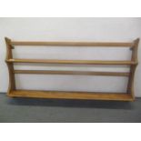 A 1960's Ercol retro beech and elm wall mounted plate rack by Lucian Ercolani, 49 h x 96.5cm w