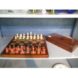A Victorian Staunton pattern natural bone and stained red bone chess set with inlaid wooden board,