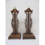 A pair of late 20th century Chinese hardwood table lamps with carved and pierced ornament 36cm h (