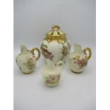 A pair of Royal Worcester blush ivory globular jugs with ribbed gilt handles and one smaller example