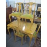 A Queen Anne style extending dining table with four chairs together with a matching sideboard