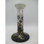 A Moorcroft pottery candlestick 21cm high decorated in the Blackberries pattern, impressed and