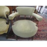 A Victorian walnut tub chair having pillar framed supports and turned front legs