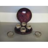 A cased set of four Victorian silver salts of circular form with repousse scrolled leaf