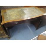 A late 19th century mahogany Shoolbred leather topped desk having two inset drawers and tapering