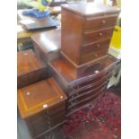 A reproduction mahogany serpentine fronted chest of four long drawers together with two bedside