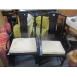 Two reproduction Chinese black lacquered armchairs