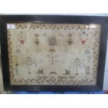 An 1810 sampler by Charlotte Le Patourel, having a strawberry needlepoint border, two figures, two