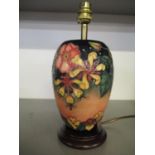 A Moorcroft Oberon pattern table lamp of slender ovoid form mounted on a wooden base 28cm h (