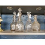 Four 19th century glass decanters to include a pair with line cut decoration