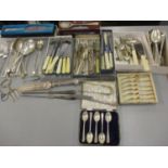 A quantity of cutlery and flatware to include a silver handled cake knife, five silver teaspoons,