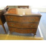An early 20th century walnut serpentine fronted chest of two short and two long drawers on four