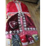 Two late 19th century Middle Eastern embroidered velvet shoulder capes, in two tones of red,