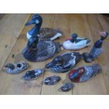 A group of wooden and painted decoy style models of ducks and similar together with a clothes