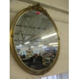 An Edwardian gilt oval wall mirror with ivy decoration 79 x 60cm