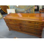 A reproduction yew cross banded bank of drawers A/F, 76 x 152 x 47cm