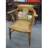 An elm and cane Captain's chair