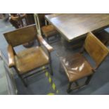 A mid 20th century oak extendable refectory table with five matching dining chairs and one carver