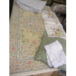 A cream crewel work rug 150 x 88cm together with mixed vintage table linen, a cushion and a large
