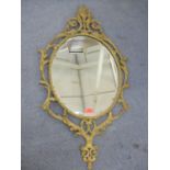 A Victorian gilt gesso oval mirror with leaf ornament