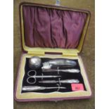 An early 20th century silver handled manicure set, not including the scissors, in a lined box