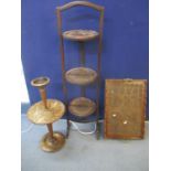A carved twin handled treen tray, a three tier folding Circa 1900's cake stand and a smokers
