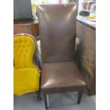 A tall dark brown leather high backed dining chair on stained mahogany legs 134 h x 59cm d