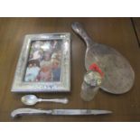 A group of silver items comprising a silver backed hand mirror, a silver topped dressing table
