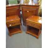 A pair of reproduction yew bedside tables with brushing slides and single drawers together a pair of