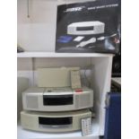 A Bose CD player in white, a Bose radio in white and other Bose items