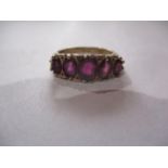 A 9ct gold and five red stone ring, total weight 4.95g, ring size UK letter Q