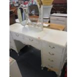 A French style cream wooden chest of five drawers, a matching dressing table and triple mirror