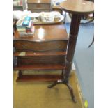 A mahogany three tier open wall shelf unit with scrolled supports together with an early 20th