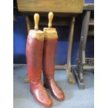 A pair of 20th Century reddish brown ladies leather riding boots and a pair of vintage wooden boot