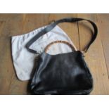 A Gucci black lambskin leather handbag with bamboo handles and gold tone hardware, serial no 001.