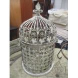 A metal bird cage having a dome top with leaf finial and rope twist handles 71cm h