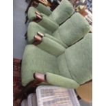 Three Parker Knoll upholstered easy chairs having mahogany stained frame and green upholstery
