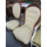A pair of walnut show wood nursing chairs with cream upholstery