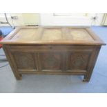 An 18th century oak tri-panelled coffer A/F with candle compartment, 62 x 107 x 54cm