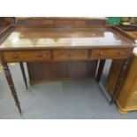 A Georgian mahogany serving table with galleried to, having three small drawers on ring turned