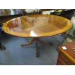 A reproduction William Tillman circular mahogany cross banded breakfast table 162cm diameter