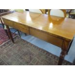 An early 20th century mahogany serving table with two drawers above fluted legs 81 x 146 x 61cm