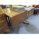 A 20th century mahogany drop leaf dining table on quadrofoil base 75 h x 65 d x 107cm w (unextended)