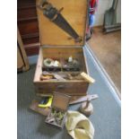 A stained vintage pine tool box containing wooden handled tools, door furniture and other items