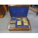 An oak cased canteen of cutlery for a setting of twelve, except the knives and serving cutlery,