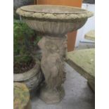 A garden stoneware bird bath, the column in the form of three nude ladies raised on an octagonal