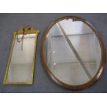 An early 20th century walnut oval mirror with gilt ornament 85 x 109cm together with a gilt